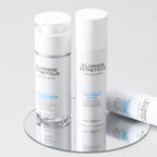 D'lumiere Esthétique skincare products on a reflective surface with a light gray background