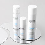 Skincare products on a rotating stand with a neutral background