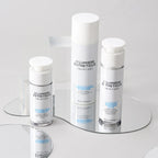 Skincare products from D'Lumiere Esthetique on a reflective surface with a light gray background